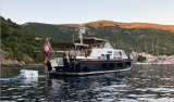 Children playing onboard a boat in Norway in the sunset