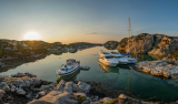 Boats and sailboat moored up in the sunset in Norway